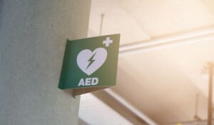 A green AED sign affixed to a wall